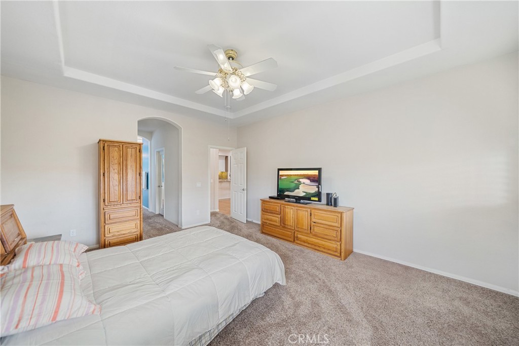 28713 Raintree Drive Menifee, CA 92584 - Photo 20 of 56 a bedroom with a bed and a chandelier