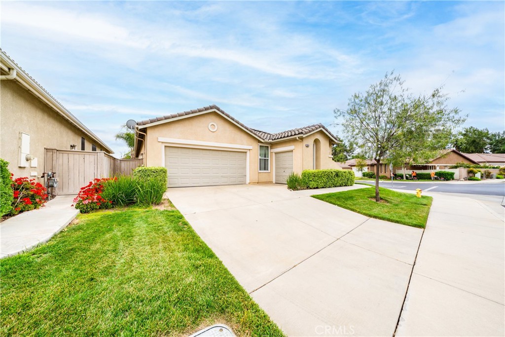 28713 Raintree Drive Menifee, CA 92584 - Photo 2 of 56 a view of house with garden and tall tress