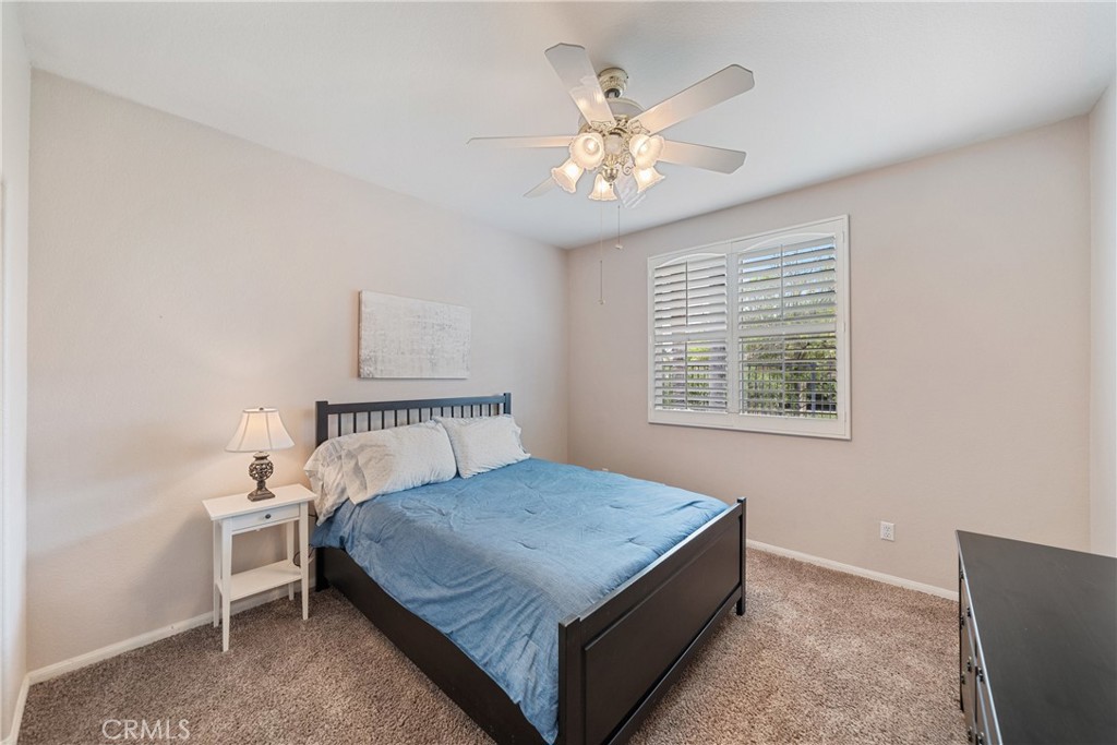 28713 Raintree Drive Menifee, CA 92584 - Photo 29 of 56 a bedroom with a bed and a chandelier