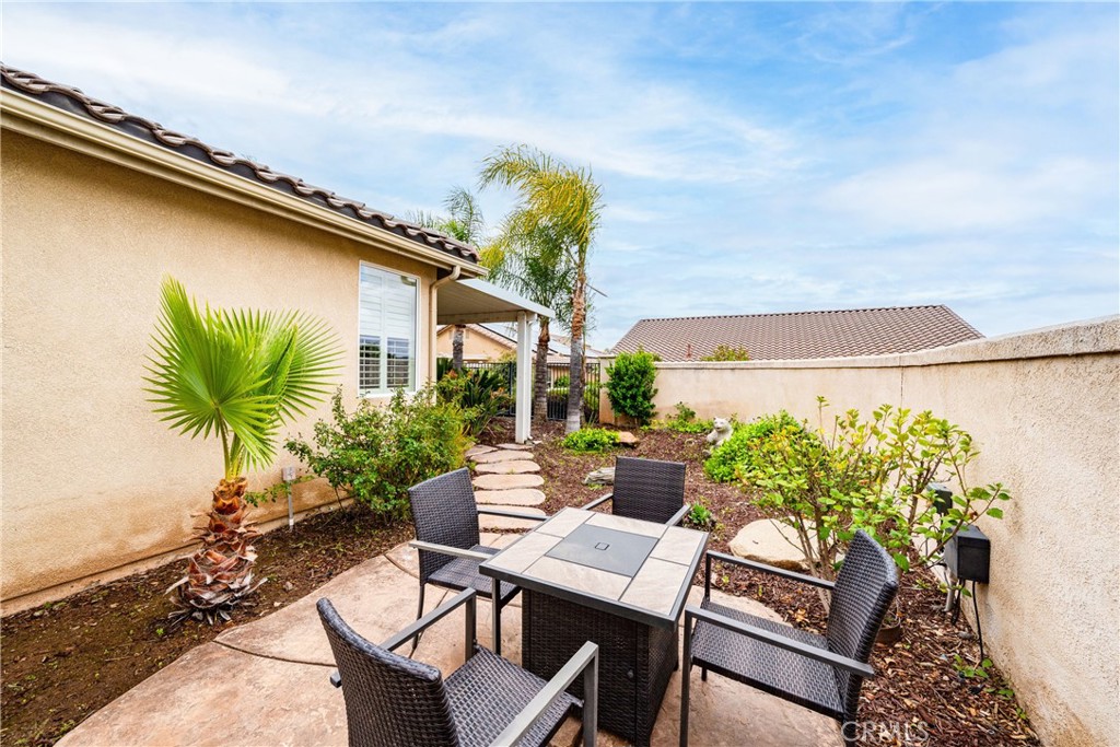 28713 Raintree Drive Menifee, CA 92584 - Photo 32 of 56 a view of a backyard with plants and a patio