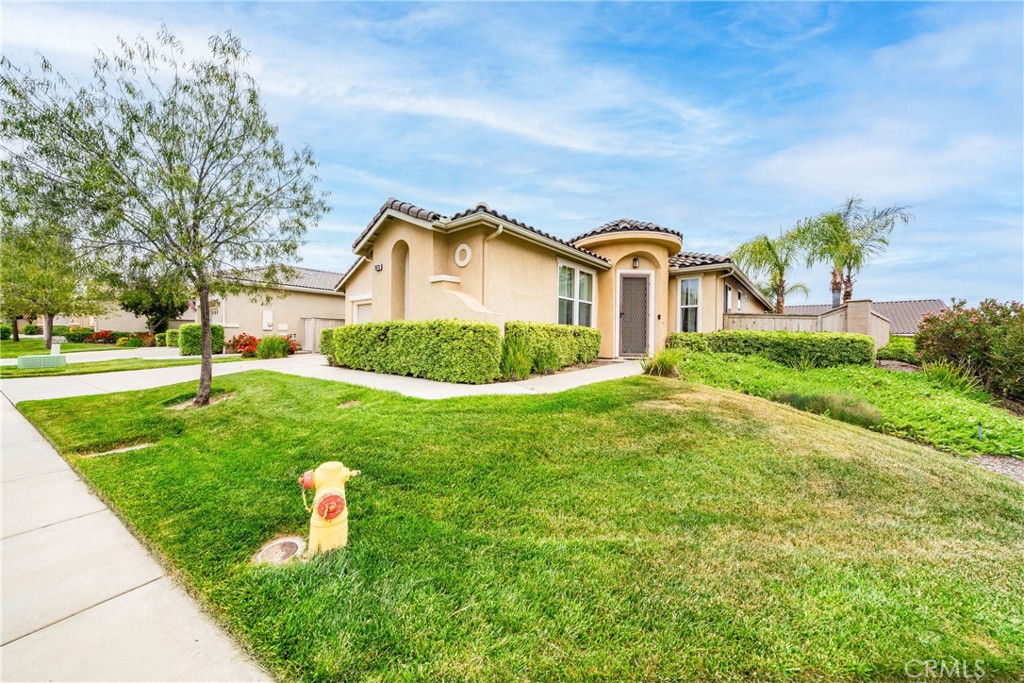 28713 Raintree Drive Menifee, CA 92584 - Photo 4 of 56 a front view of a house with a yard