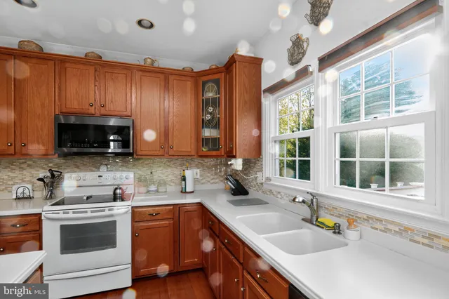 a kitchen with a sink stove and microwave