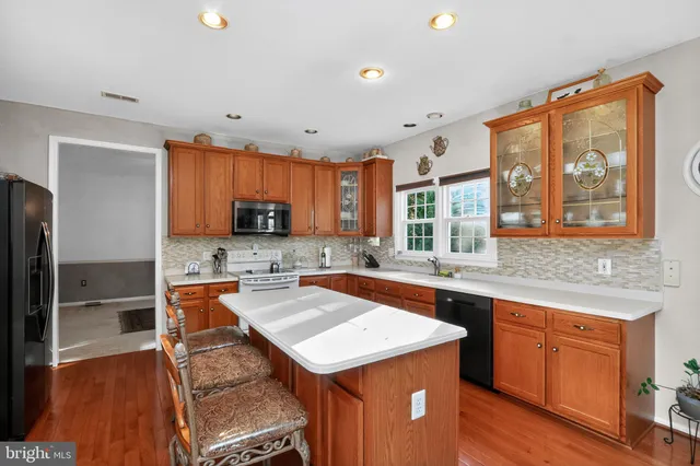 a kitchen with a stove a sink and a refrigerator