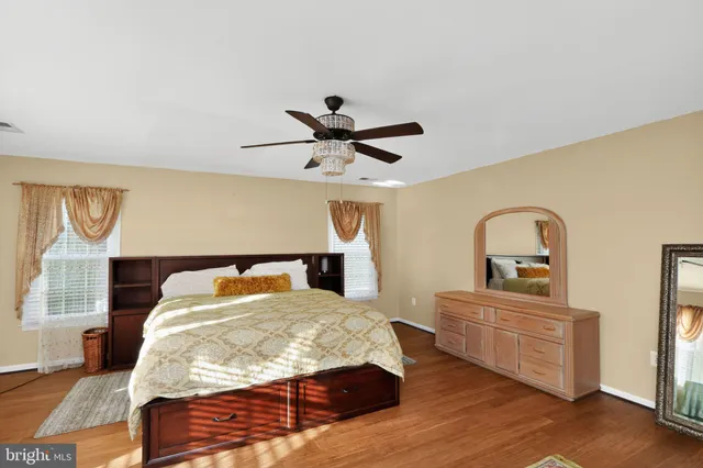 a spacious bedroom with a bed couch and a window