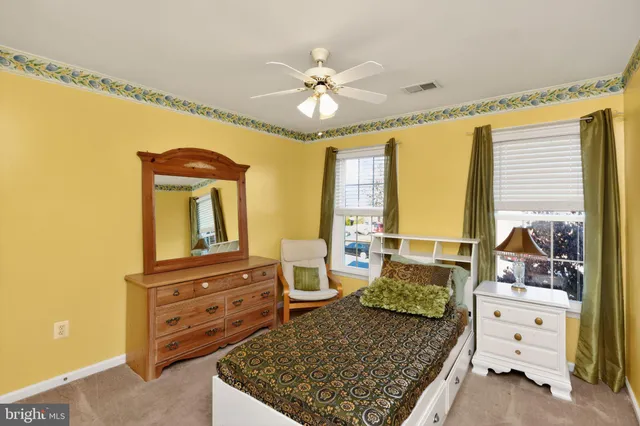 a view of an empty room with a window and cabinet
