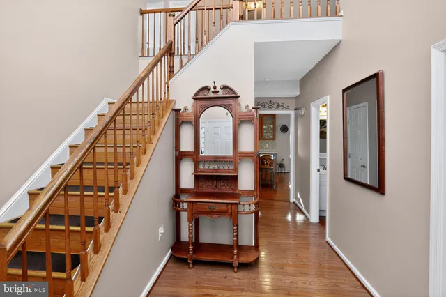 a view of entryway and hall with wooden floor