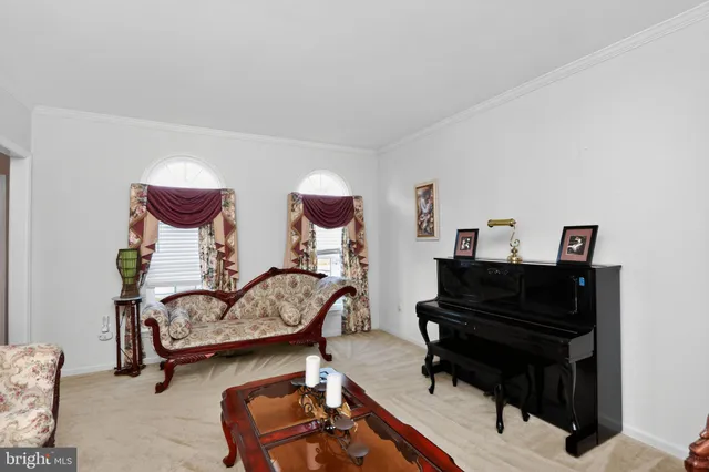 a living room with furniture and a piano