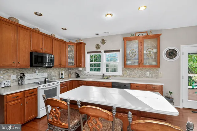 a kitchen with stainless steel appliances granite countertop a sink and cabinets