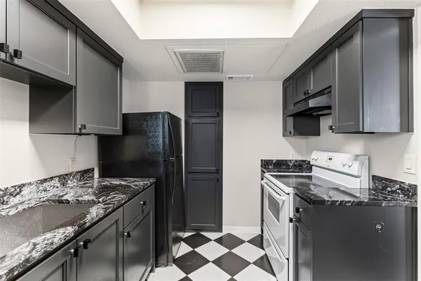 a kitchen with stainless steel appliances granite countertop a stove a refrigerator and a sink