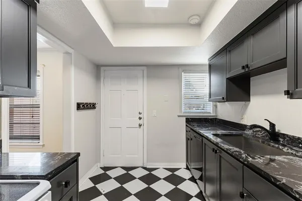 a kitchen with a sink stove and cabinets