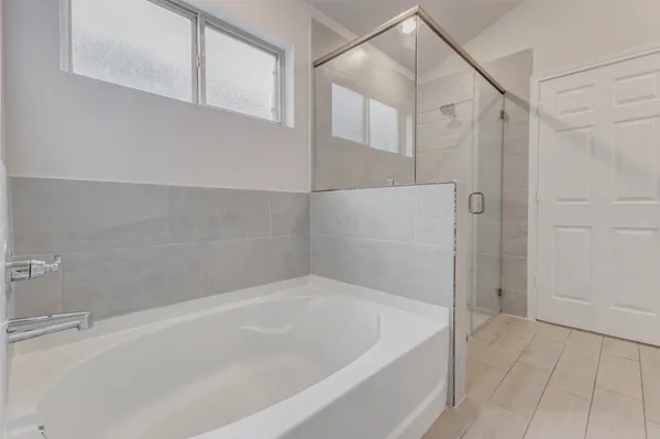 a bathroom with a bathtub and shower