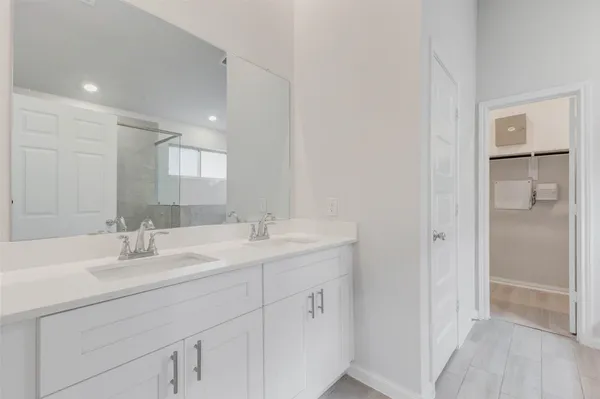 a bathroom with a sink double vanity and a mirror