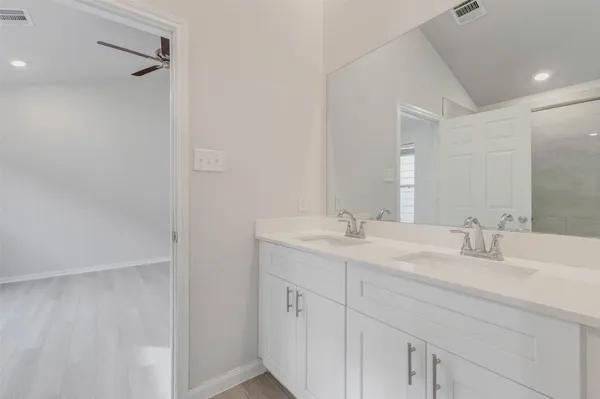 a bathroom with a double vanity sink and a mirror