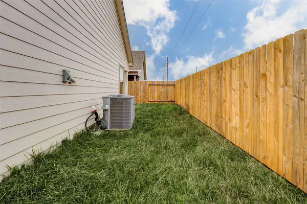 a view of a back yard with a wooden fence