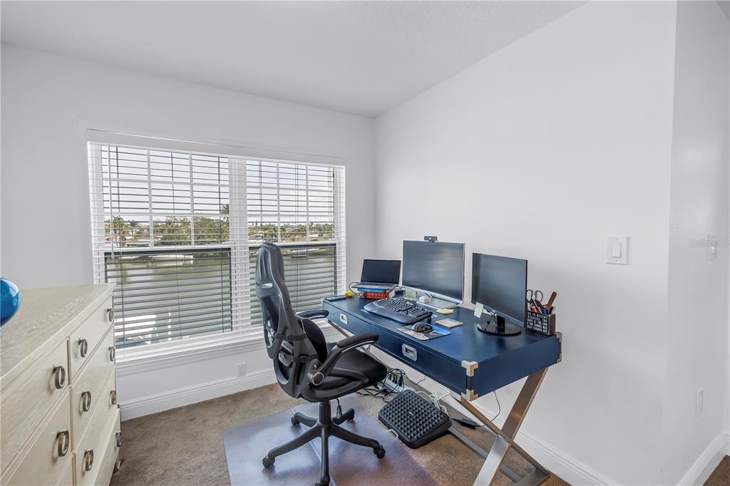 100 Windrush Boulevard, Unit 1 Indian Rocks Beach, FL 33785 - Photo 16 of 37 a view of a workspace with furniture and a window