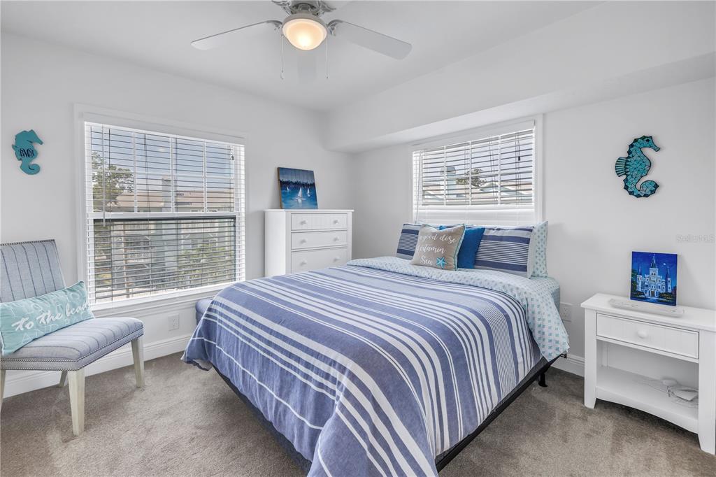100 Windrush Boulevard, Unit 1 Indian Rocks Beach, FL 33785 - Photo 20 of 37 a bedroom with a bed and a window