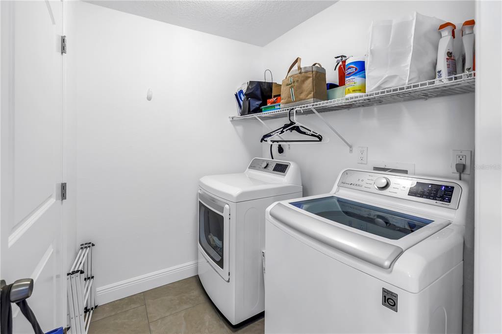 100 Windrush Boulevard, Unit 1 Indian Rocks Beach, FL 33785 - Photo 22 of 37 a utility room with dryer and washer