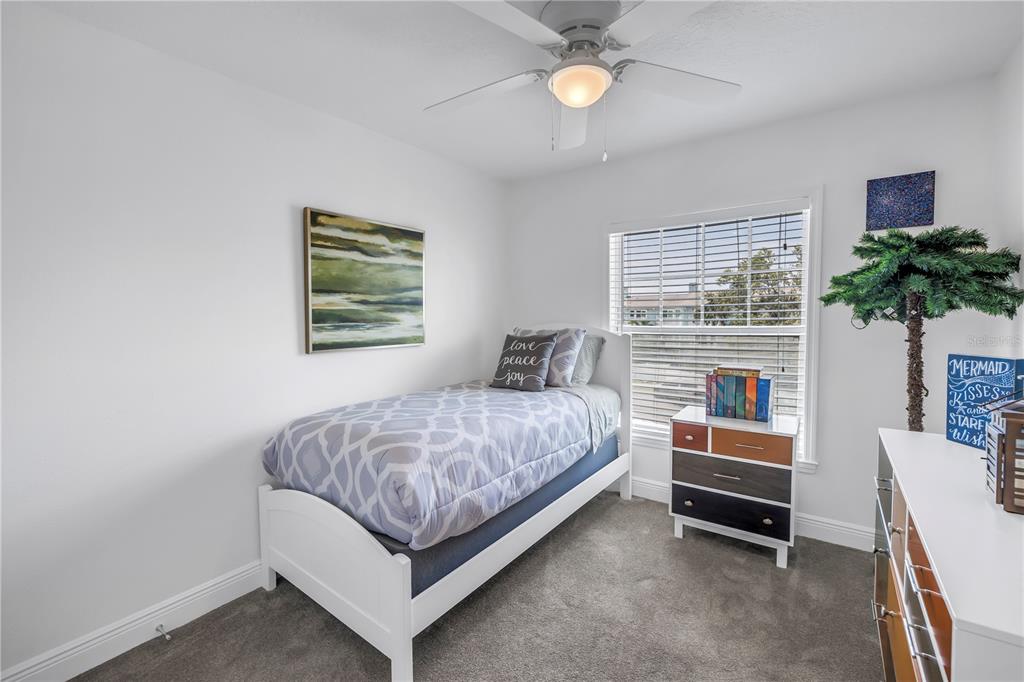 100 Windrush Boulevard, Unit 1 Indian Rocks Beach, FL 33785 - Photo 23 of 37 a bedroom with a bed and a potted plant