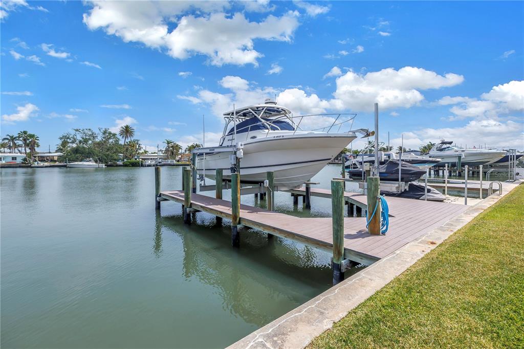 100 Windrush Boulevard, Unit 1 Indian Rocks Beach, FL 33785 - Photo 26 of 37 a view of a house with pool and lake view