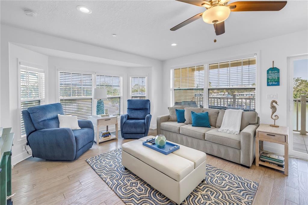 100 Windrush Boulevard, Unit 1 Indian Rocks Beach, FL 33785 - Photo 5 of 37 a living room with furniture and a large window