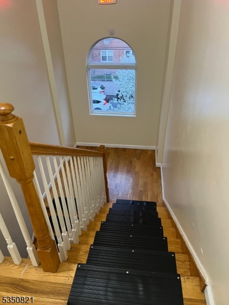 89 Chadwick Avenue, Unit 3 Newark, NJ 07108 - Photo 11 of 28 a view of a hallway with wooden floor and stairs