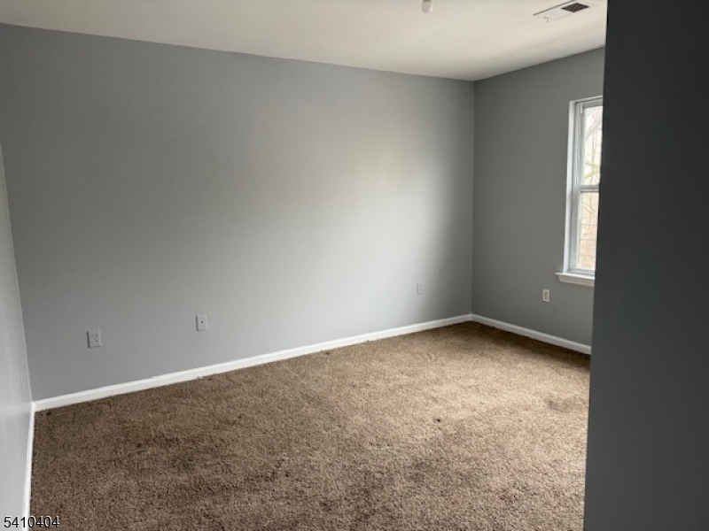 89 Chadwick Avenue, Unit 3 Newark, NJ 07108 - Photo 17 of 28 a view of a room that has a window in it