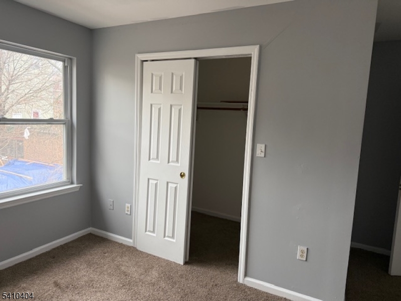 89 Chadwick Avenue, Unit 3 Newark, NJ 07108 - Photo 18 of 28 an empty room with windows and closet