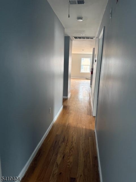 89 Chadwick Avenue, Unit 3 Newark, NJ 07108 - Photo 19 of 28 a view of a room with wooden floor and a window