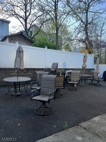 89 Chadwick Avenue, Unit 3 Newark, NJ 07108 - Photo 23 of 28 a backyard of a house with barbeque oven table and chairs