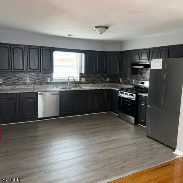 89 Chadwick Avenue, Unit 3 Newark, NJ 07108 - Photo 4 of 28 a kitchen with stainless steel appliances granite countertop a stove and a sink