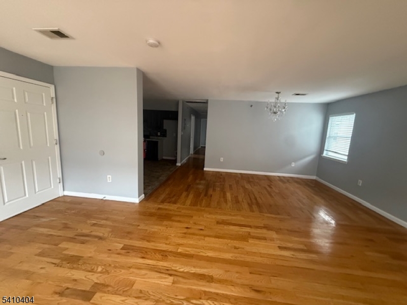 89 Chadwick Avenue, Unit 3 Newark, NJ 07108 - Photo 6 of 28 a view of empty room with wooden floor