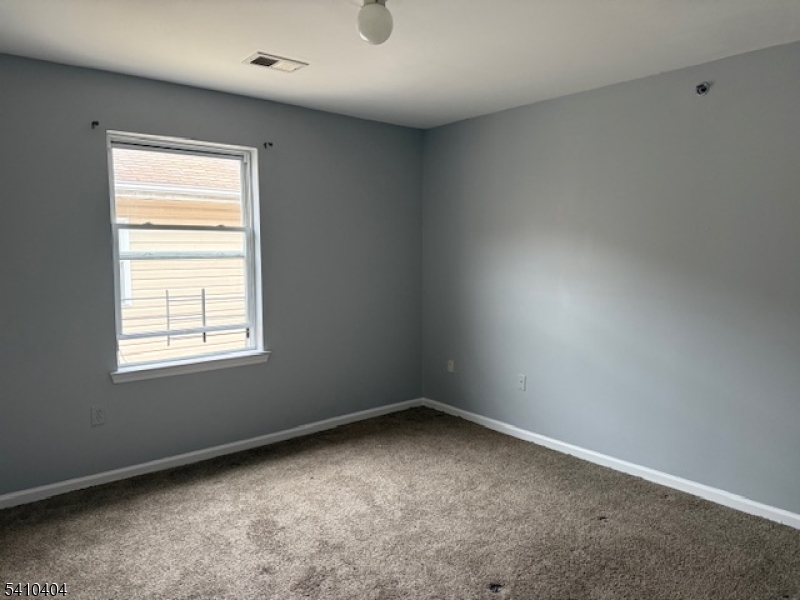 89 Chadwick Avenue, Unit 3 Newark, NJ 07108 - Photo 9 of 28 an empty room with a window
