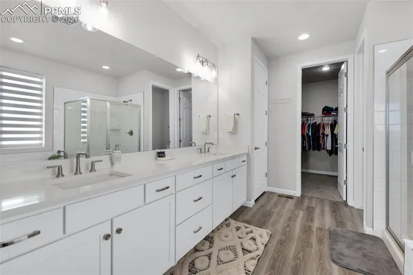 a bathroom with double vanity sink and a mirror