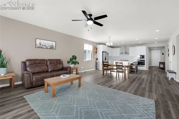 a living room with furniture and kitchen view