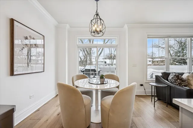 a view of a dining room with furniture large window and wooden floor