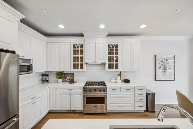 a kitchen with stainless steel appliances white cabinets and a sink
