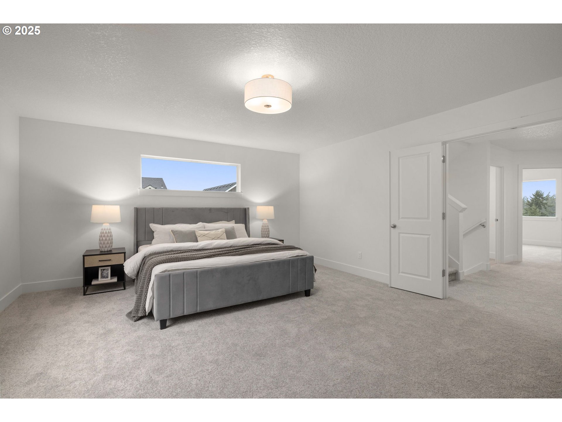 19040 Southwest Northridge Court, Unit LOT 15 Beaverton, OR 97007 - Photo 20 of 34 a spacious bedroom with a bed and a lamp
