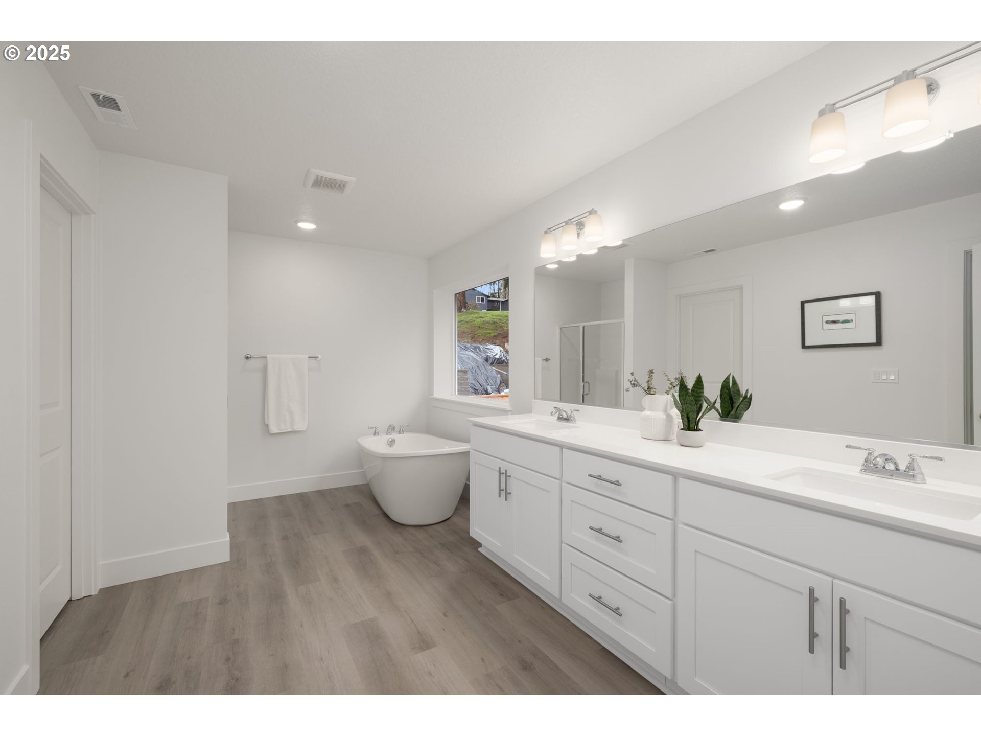 19040 Southwest Northridge Court, Unit LOT 15 Beaverton, OR 97007 - Photo 23 of 34 a spacious bathroom with a double vanity sink a toilet and a mirror