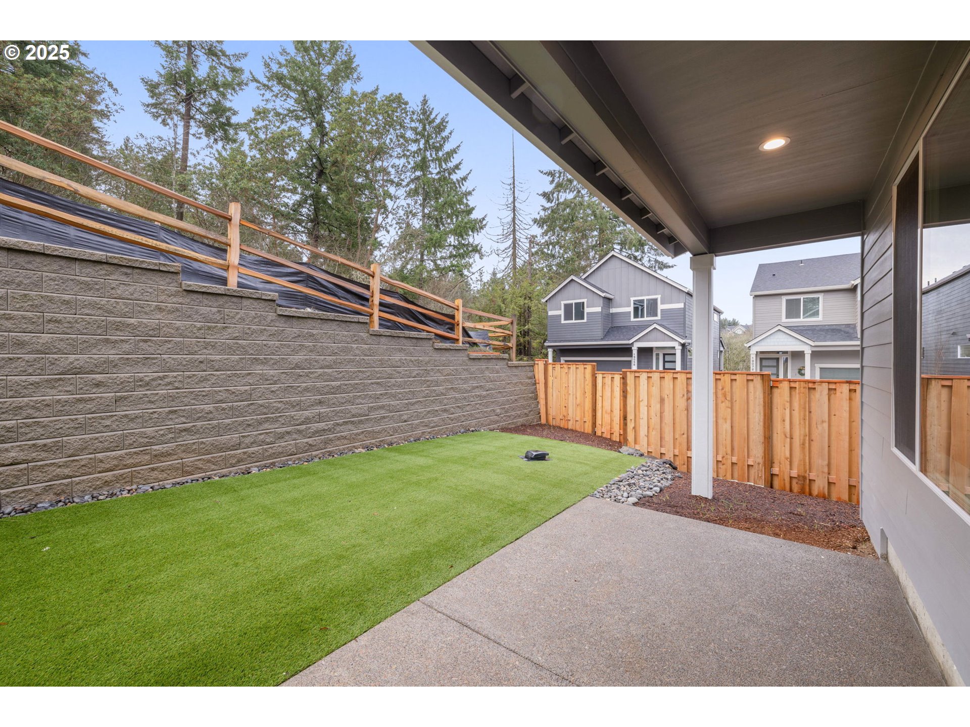 19040 Southwest Northridge Court, Unit LOT 15 Beaverton, OR 97007 - Photo 32 of 34 a view of a backyard with wooden fence and large trees