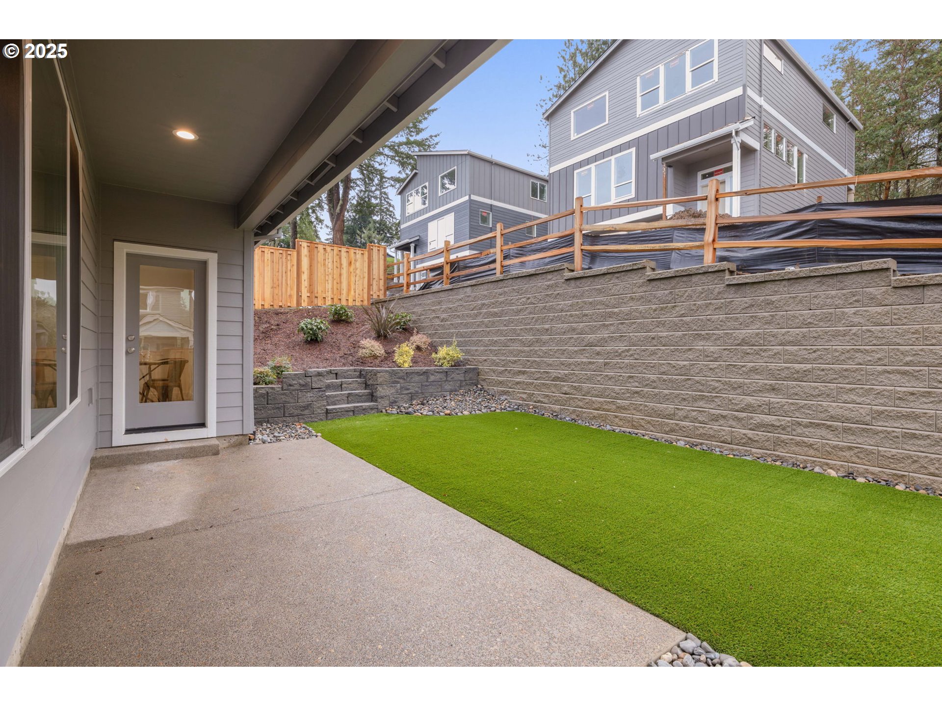 19040 Southwest Northridge Court, Unit LOT 15 Beaverton, OR 97007 - Photo 33 of 34 a backyard of a house with table and chairs