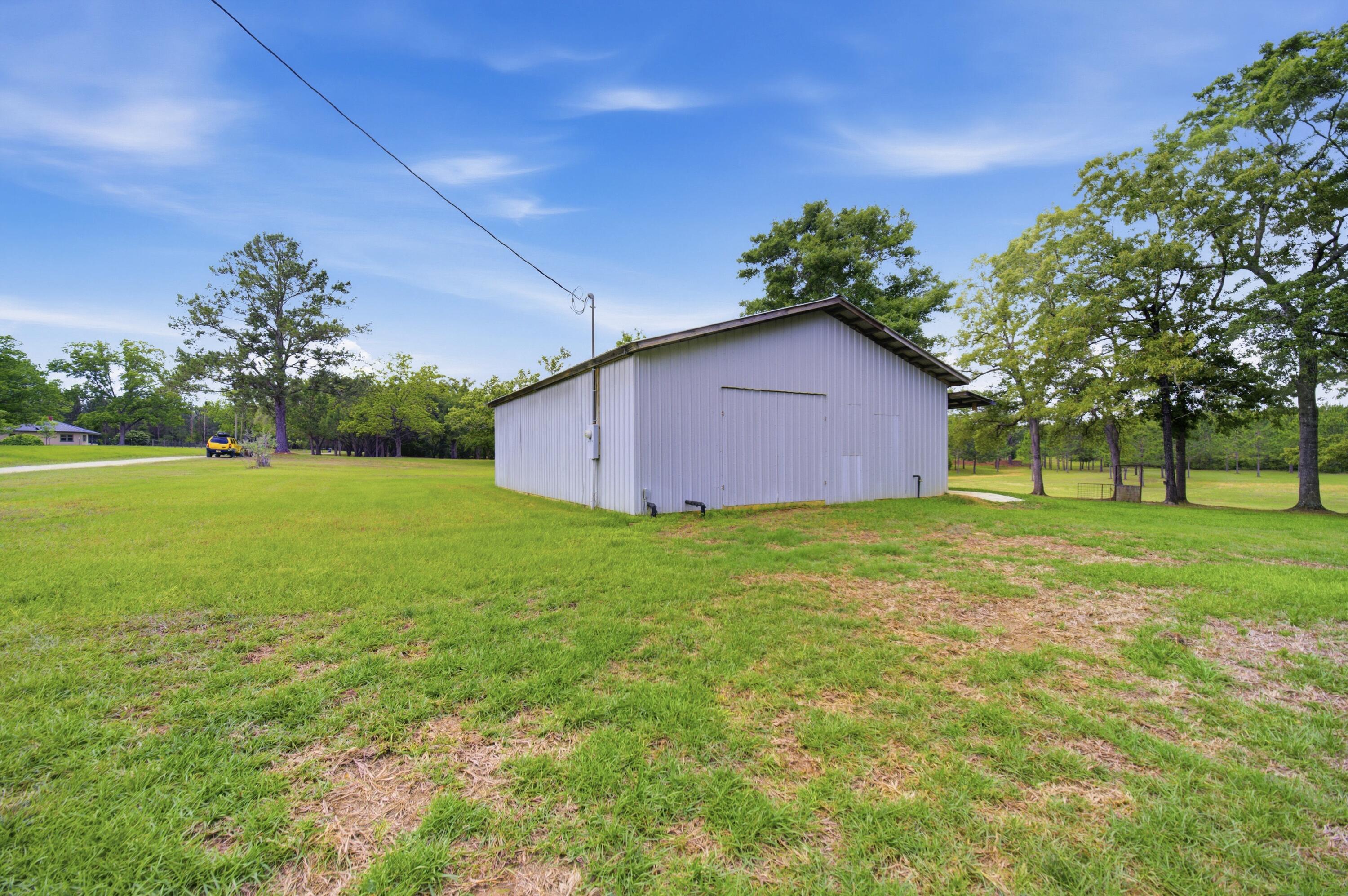 261 Wilkerson Road DeFuniak Springs, FL 32433 - Photo 69 of 76 a house with garden in front of it