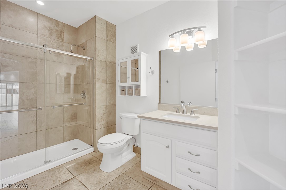 8725 West Flamingo Road, Unit 110 Las Vegas, NV 89147 - Photo 11 of 30 A well-appointed bathroom features a spacious shower and a vanity with ample storage.
