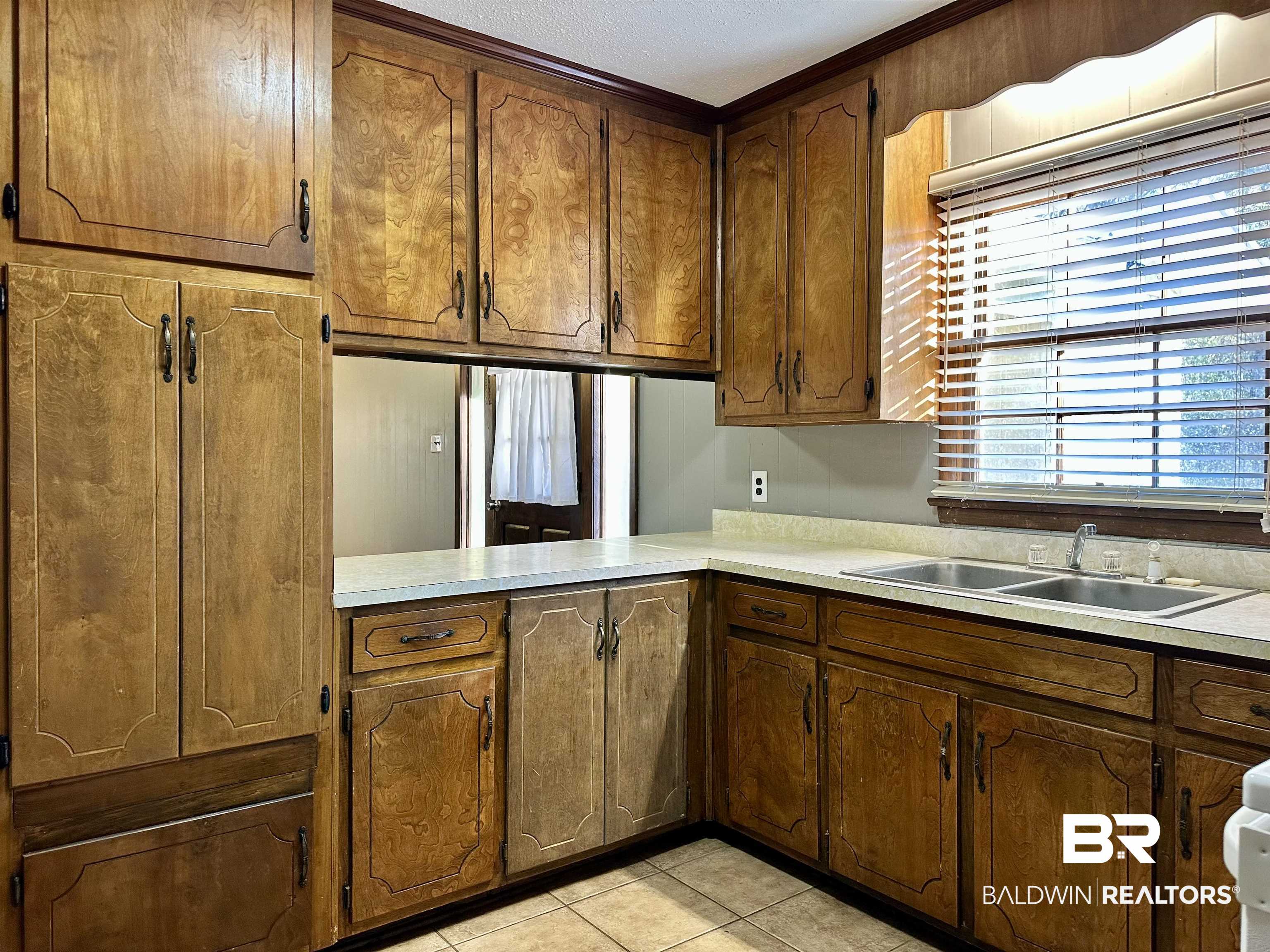 2664 Sowell Road Brewton, AL 36426 - Photo 5 of 12 Kitchen with sink and light tile patterned flooring