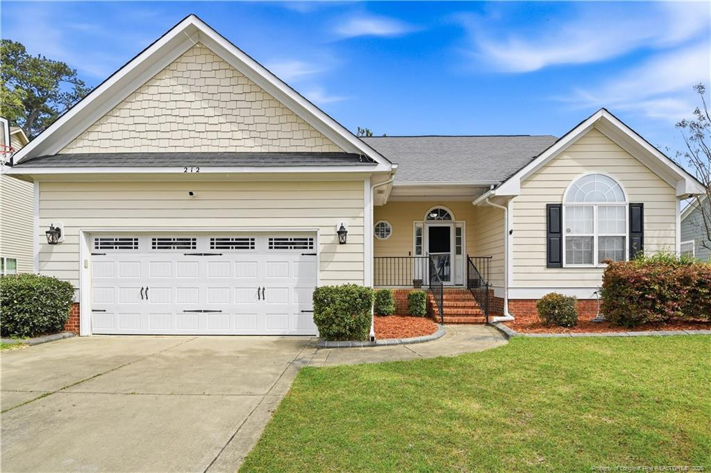 212 Lennox Loop Raeford, NC 28376 - Photo 1 of 47 a front view of a house with a yard