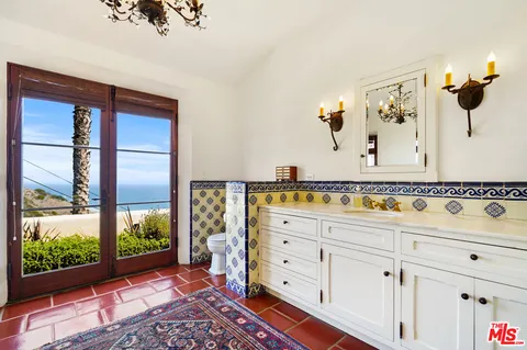 a bathroom with a bathtub and a window