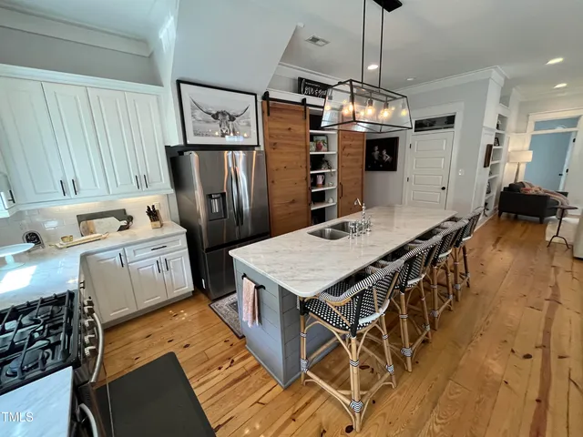 a bathroom with a sink a toilet a shower and vanity