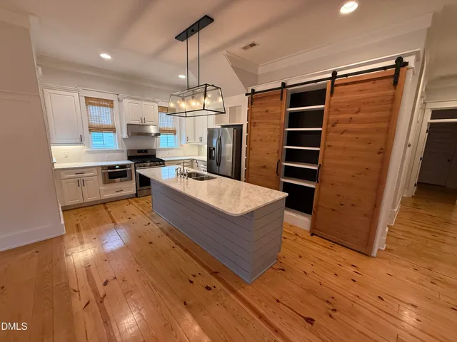 a living room with a flat screen tv and a couch