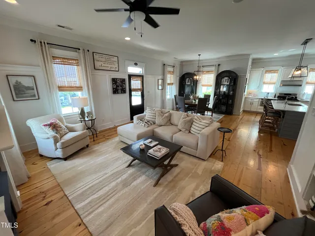 a bedroom with a bed a dresser and a flat screen tv