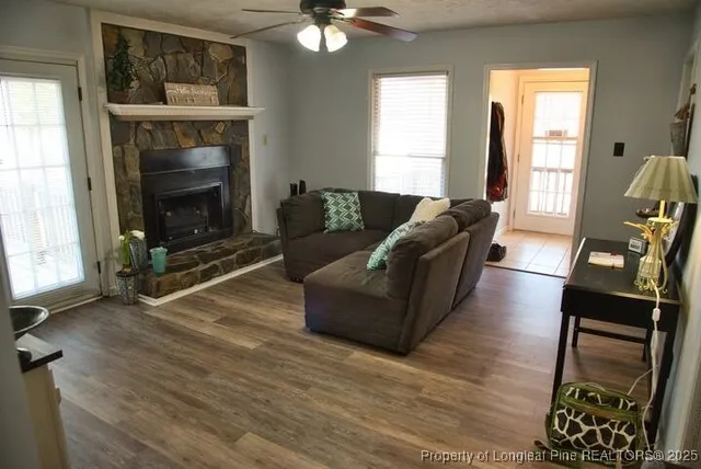 a living room with furniture and a fireplace