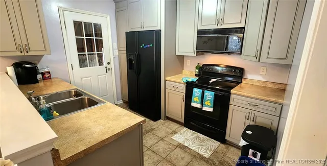 a kitchen with a refrigerator stove and sink